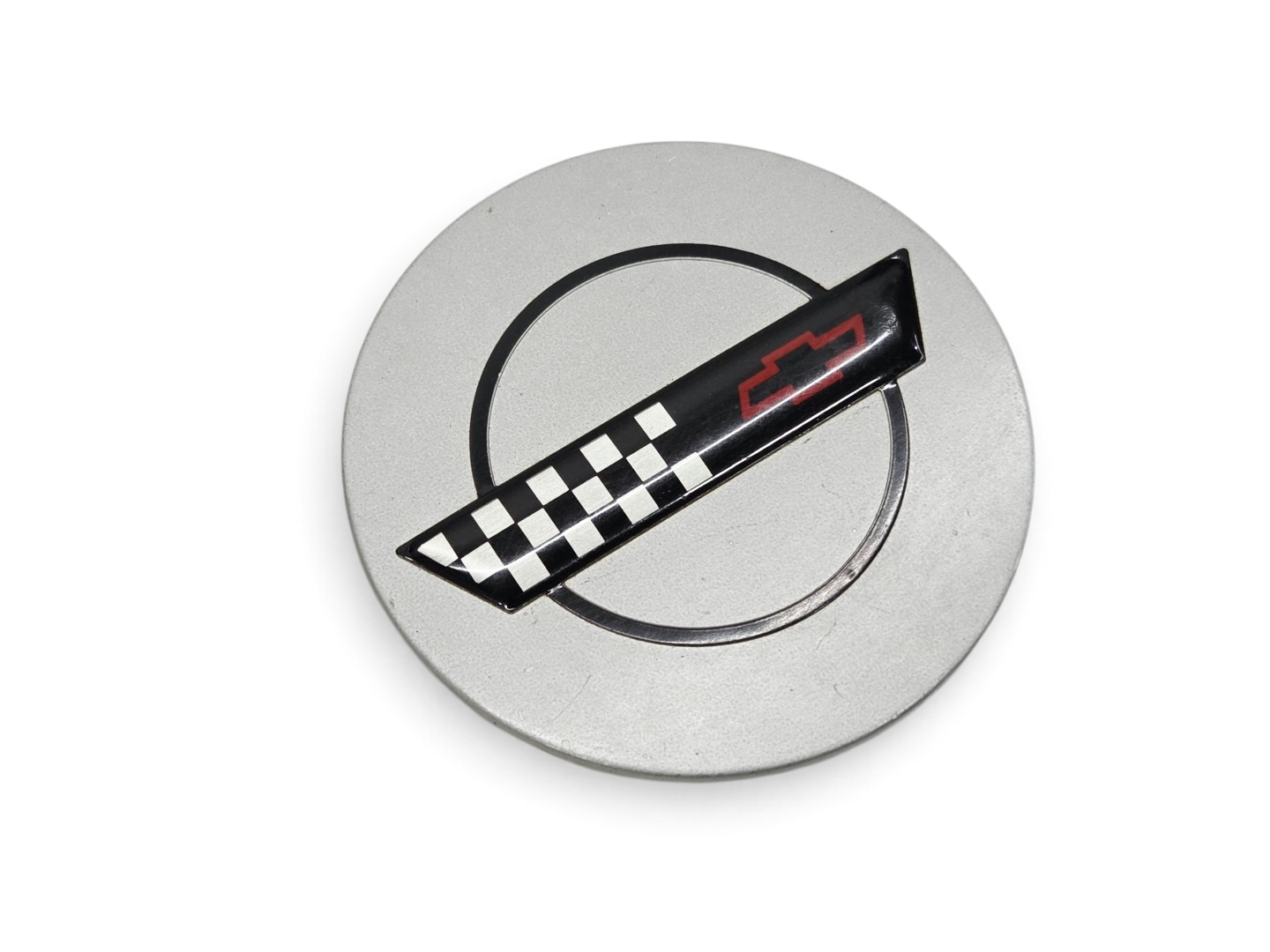 Send it Auto Parts silver OEM wheel center cap for 1991-1995 Corvette C4 ZR-1 with checkered flag emblem