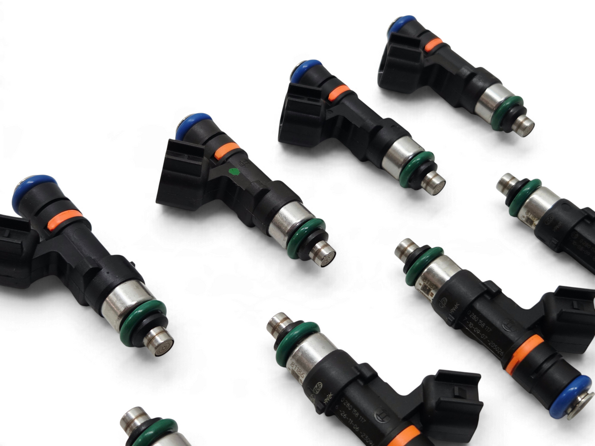 Send it Auto Parts set of eight genuine Bosch 0280158117 550cc EV14 fuel injectors with black bodies and green O-rings.