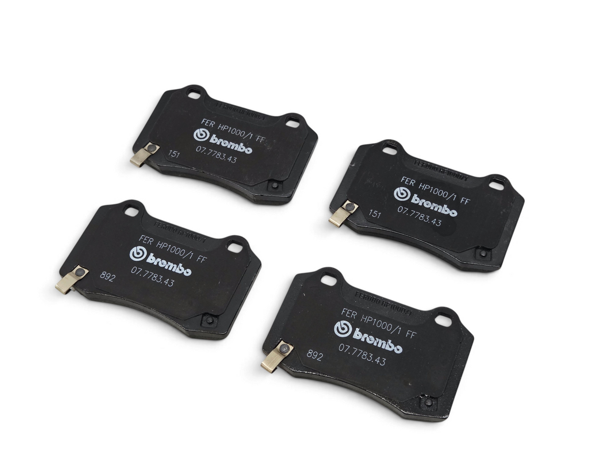 Send it Auto Parts Brembo rear disc brake pads for Camaro ZL1, CTS-V, and SS, featuring black finish and OEM markings.