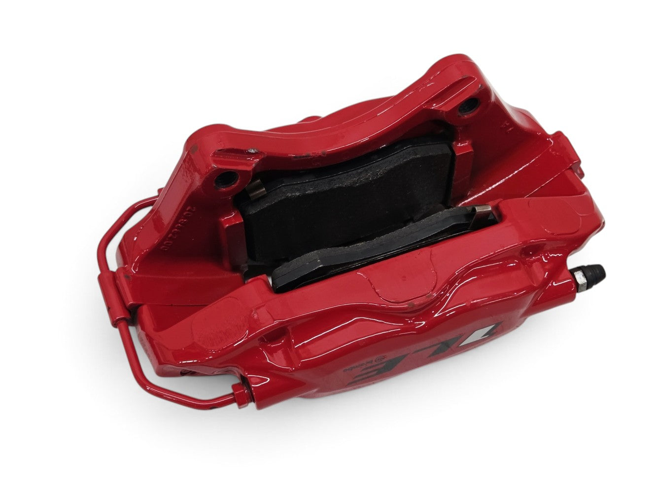 Send it Auto Parts OEM red Brembo rear brake caliper with pads for Chevrolet Camaro ZL1, isolated on white.
