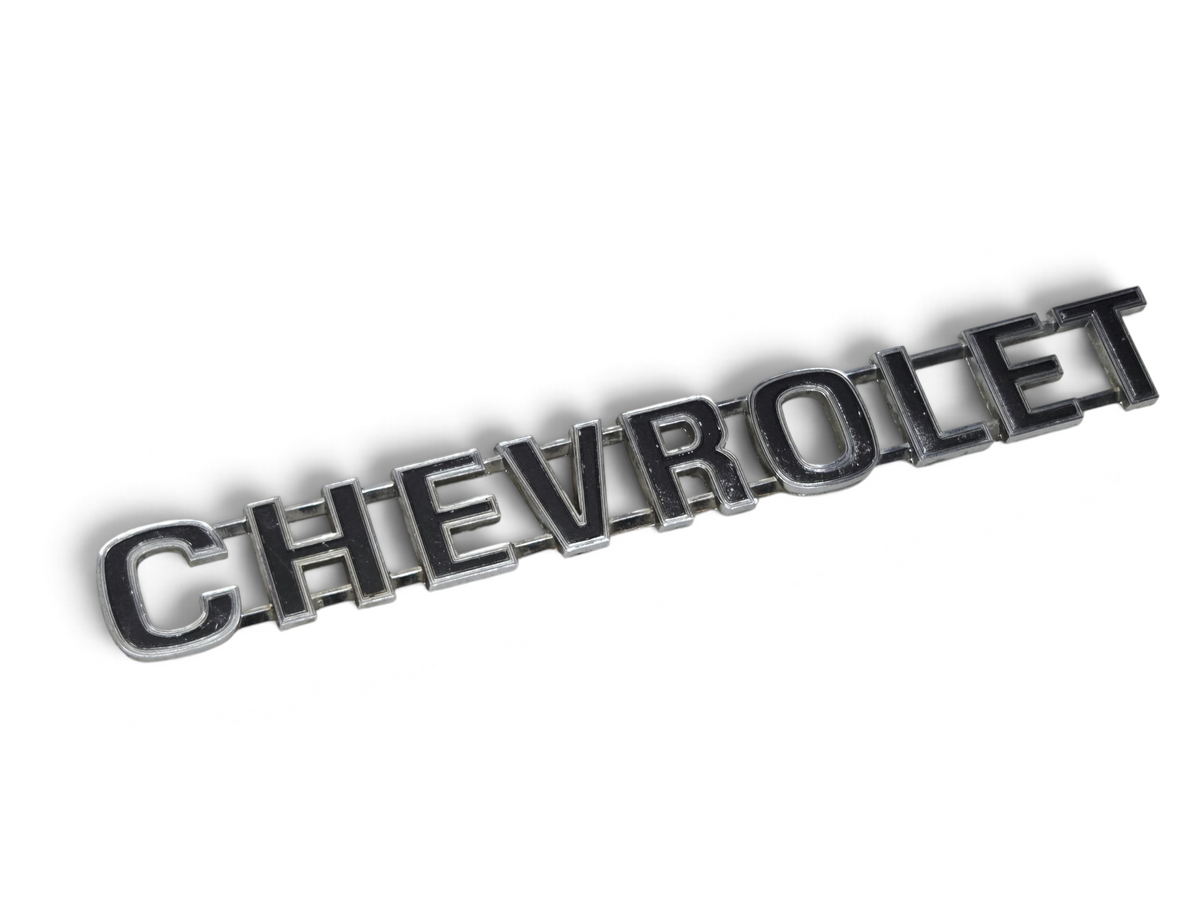Send it Auto Parts OEM Chevrolet tailgate script nameplate for 1973-1980 trucks with minor wear and missing pins