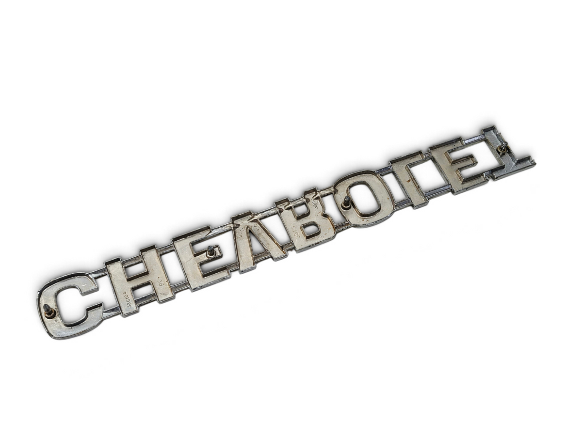 Send it Auto Parts OEM Chevrolet tailgate script nameplate for 1973-1980 trucks with minor wear and missing pins