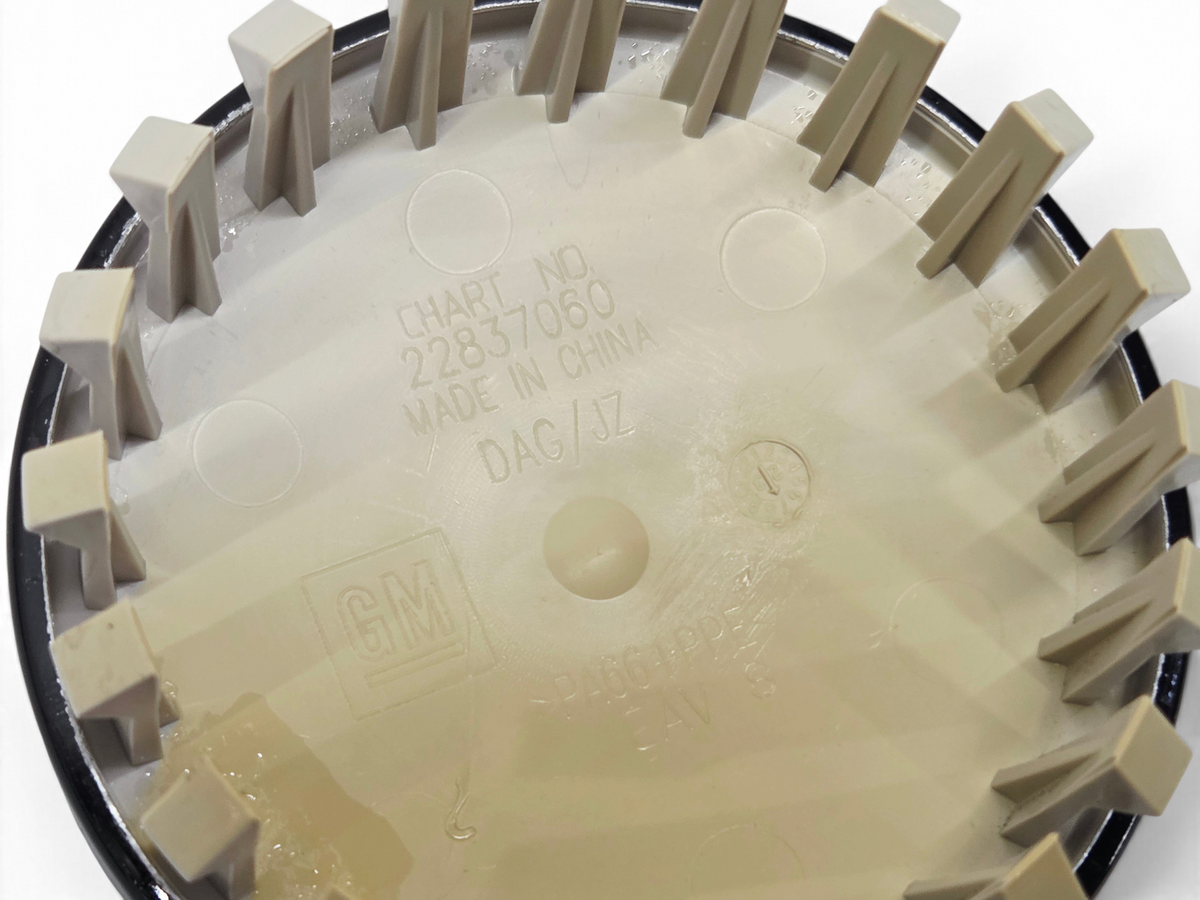 Send it Auto Parts OEM GM 22837060 Chevy wheel center cap back view showing part number and plastic construction