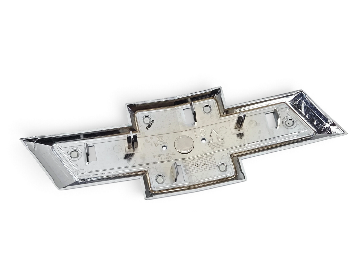 Send it Auto Parts genuine OEM black Chevrolet Silverado 1500 front grille bowtie emblem, rear view showing mounts