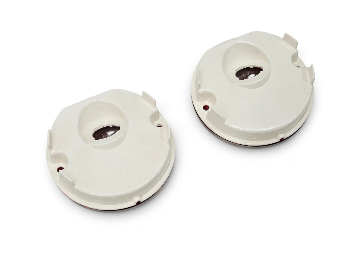 Send it Auto Parts OEM GM backup reverse lamp lenses for 1975-1979 Corvette C3, showing the white plastic back side.