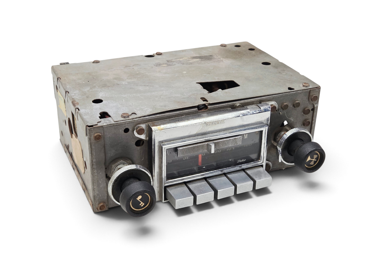 Send it Auto Parts vintage 1972-1976 Corvette C3 Delco AM FM radio with chrome faceplate and black control knobs.