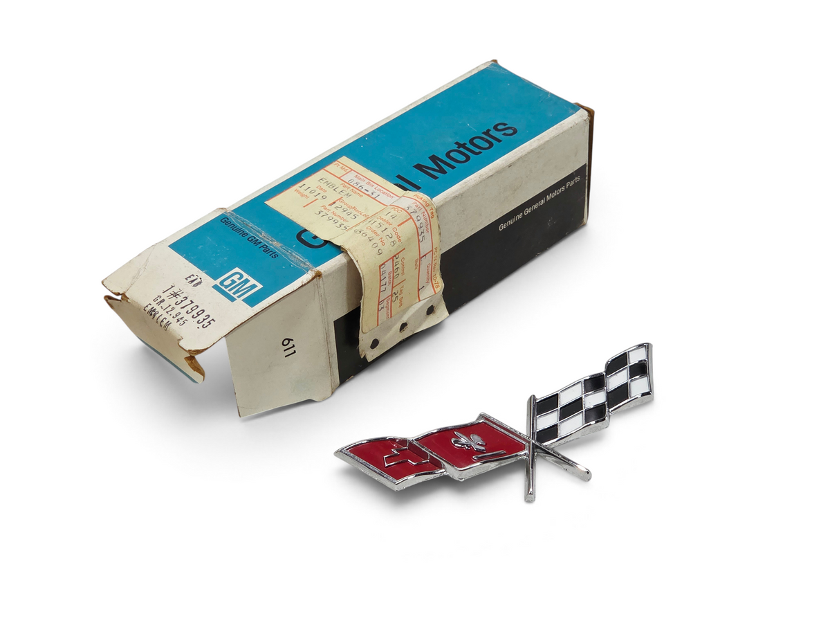 Send it Auto Parts OEM 1977 Corvette C3 fuel door cross flag emblem with original General Motors packaging