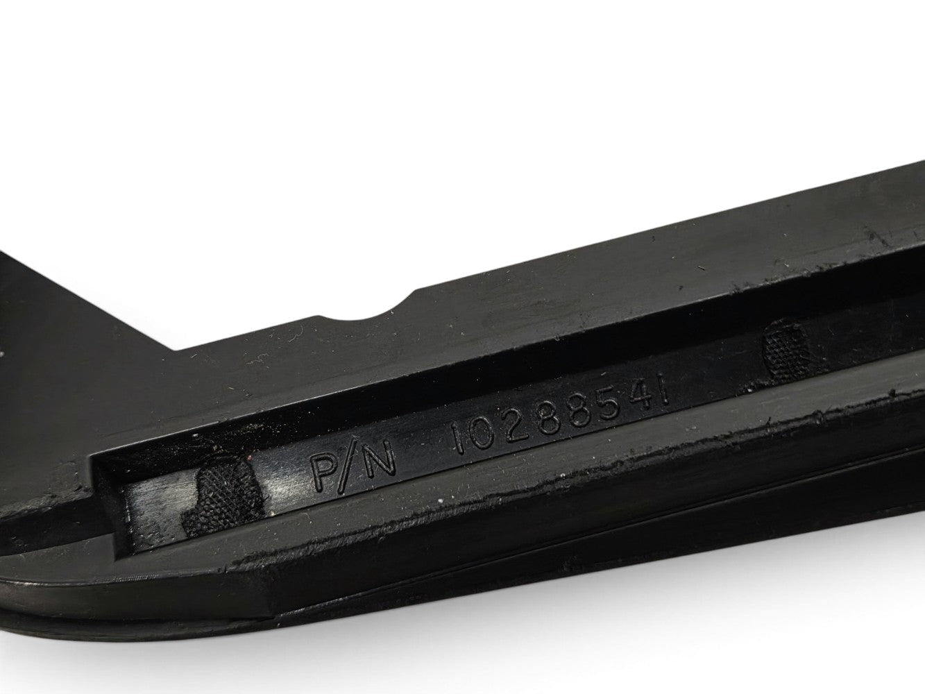 Send it Auto Parts OEM black front license plate bezel for 1997-2004 Corvette C5 showing part number 10288541