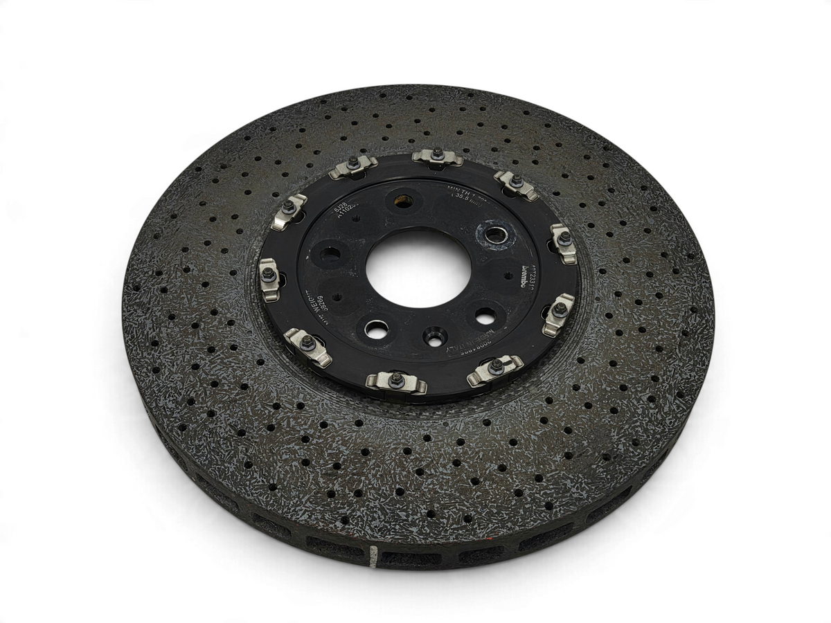 Send it Auto Parts carbon ceramic front brake rotor for Corvette C7 Z06 with visible surface wear and small chip