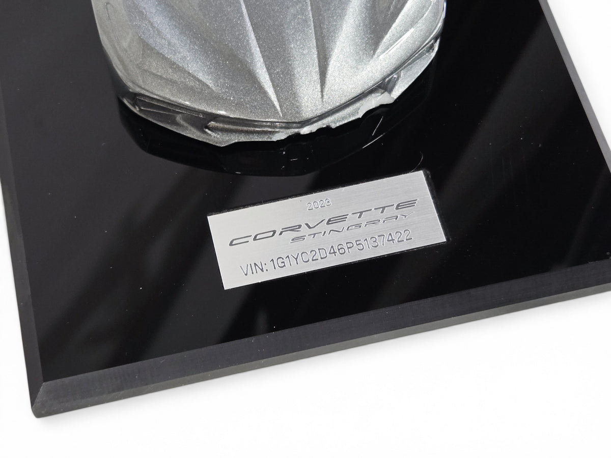Send it Auto Parts 2023 Corvette C8 speedshape model in Hypersonic Gray on a black display base with VIN plate
