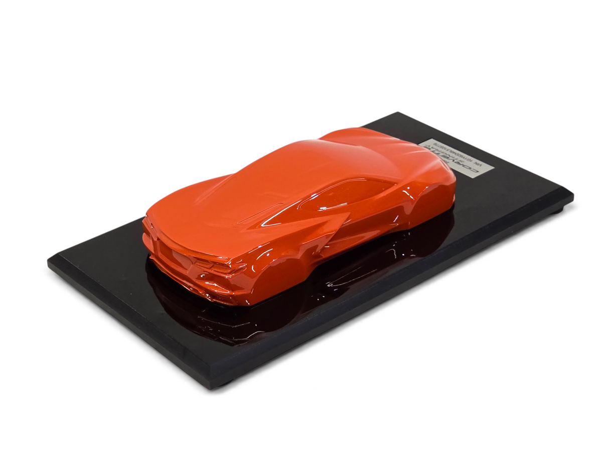 Send it Auto Parts 2020 Corvette C8 Stingray speedshape model in Sebring Orange on a black display base.