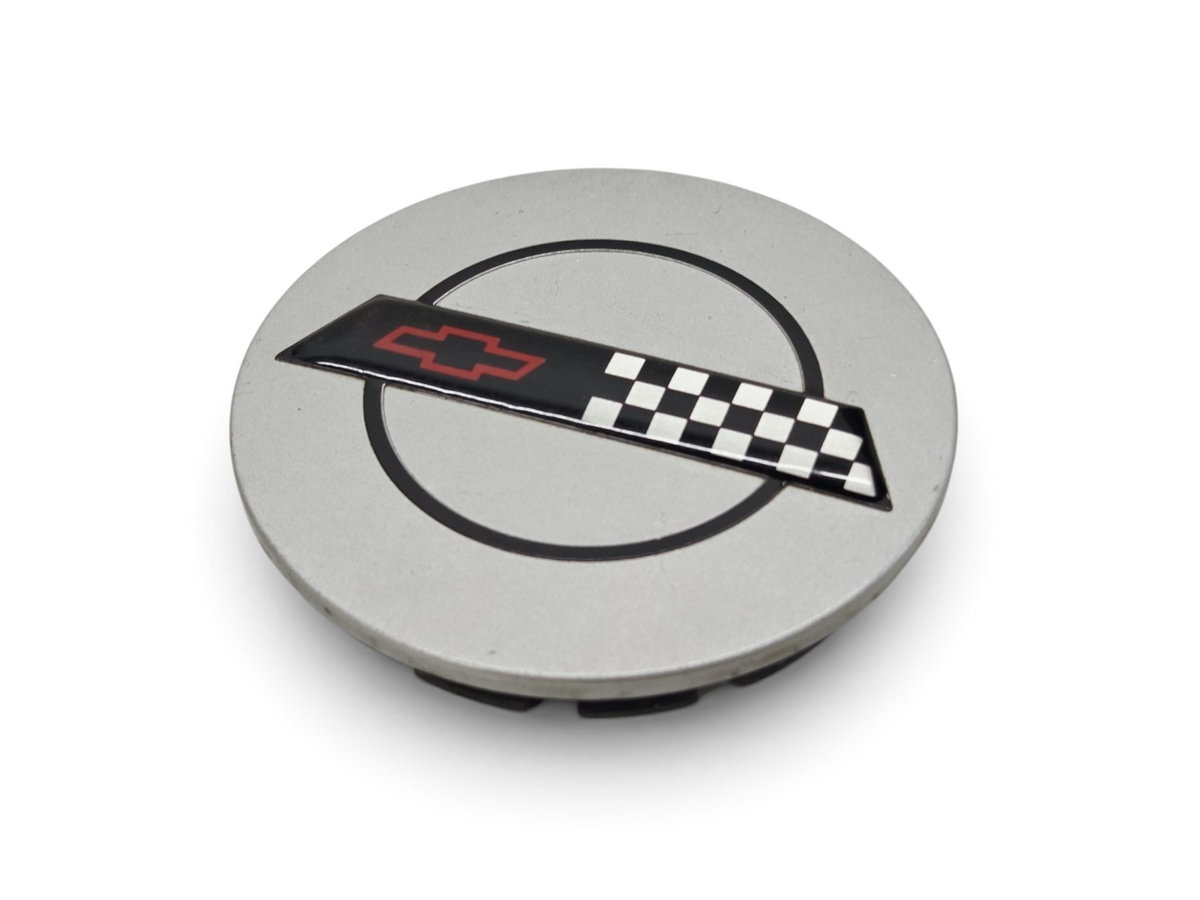 Send it Auto Parts OEM silver Corvette C4 ZR-1 wheel center cap with checkered flag emblem
