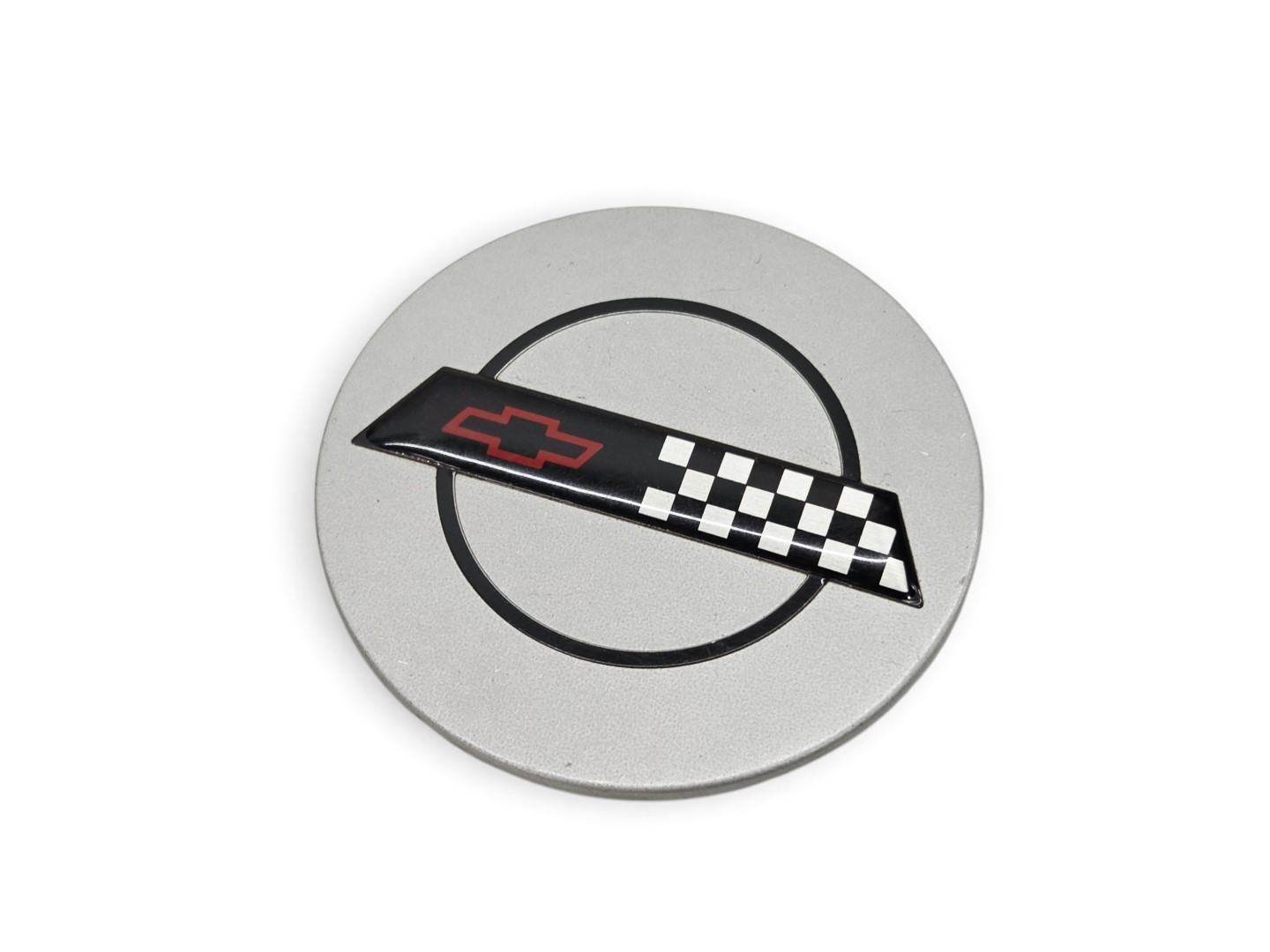 Send it Auto Parts OEM silver wheel center cap for 1991-1995 Corvette C4 ZR-1 with checkered flag emblem