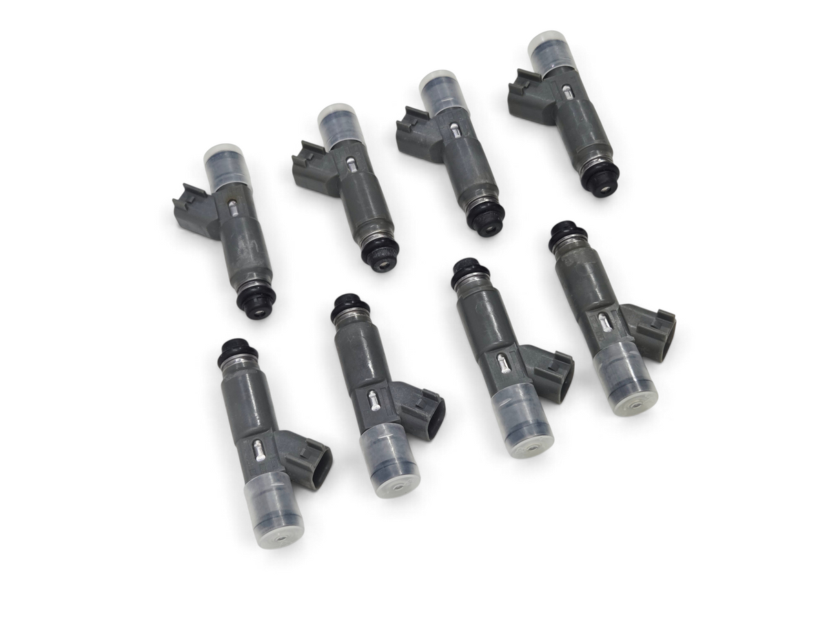 Send it Auto Parts set of eight Denso 2000cc high impedance fuel injectors with EV6 connectors on white background