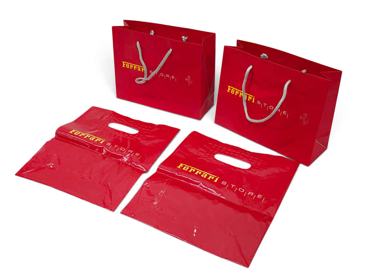 Send it Auto Parts lot of four red Ferrari Store shopping bags including two paper bags and two plastic bags