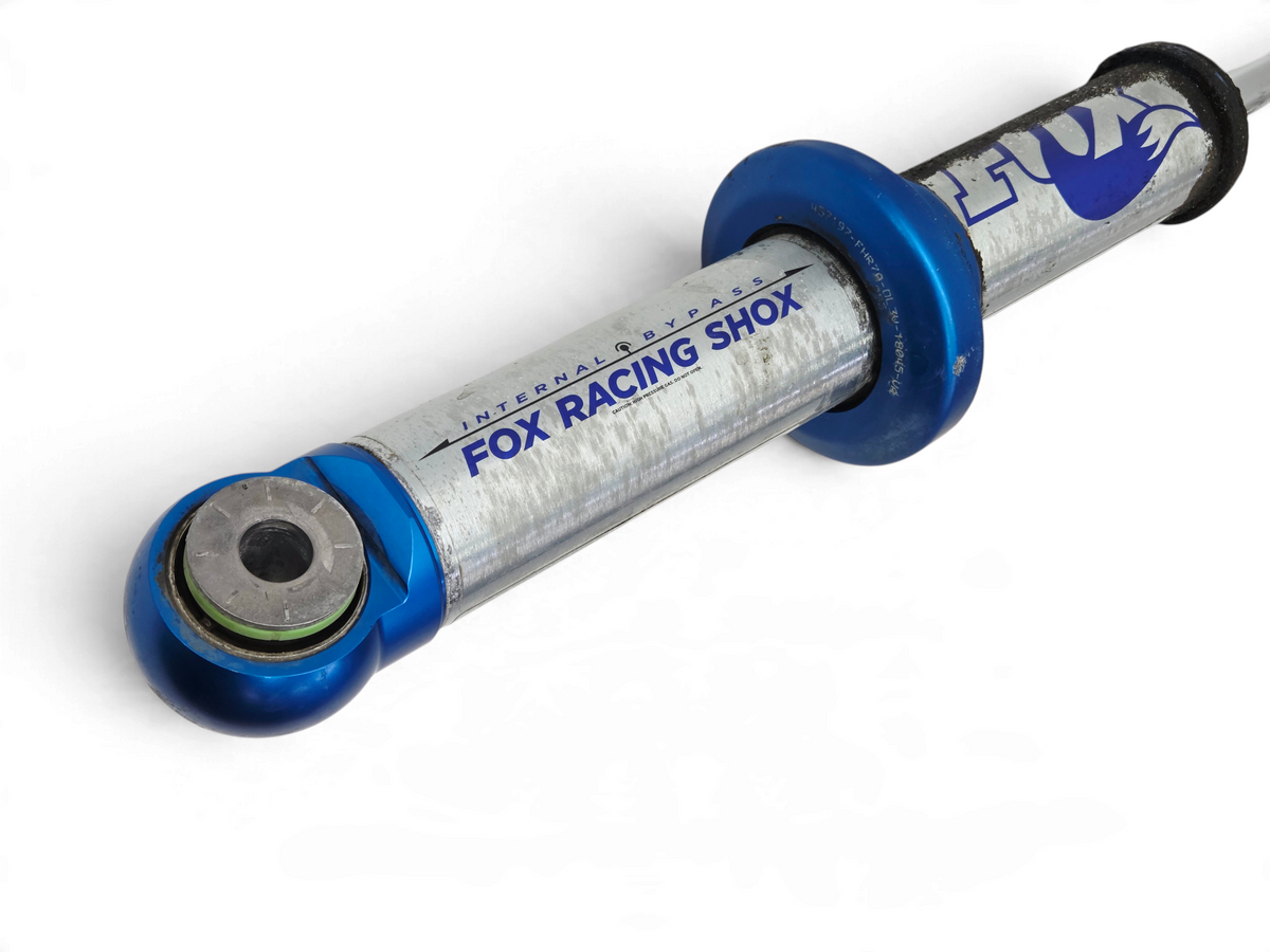 Send it Auto Parts Fox Racing Shox front shock absorber for 2010-2014 Ford F150 SVT Raptor, silver and blue finish.