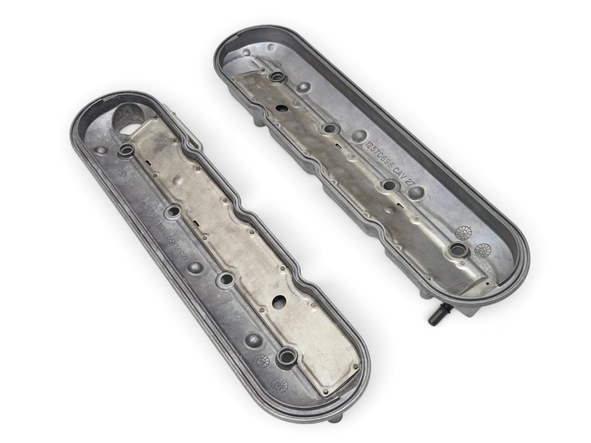 Send it Auto Parts OEM GM LS Gen IV rocker arm valve covers, silver metal finish, showing interior bolt holes.