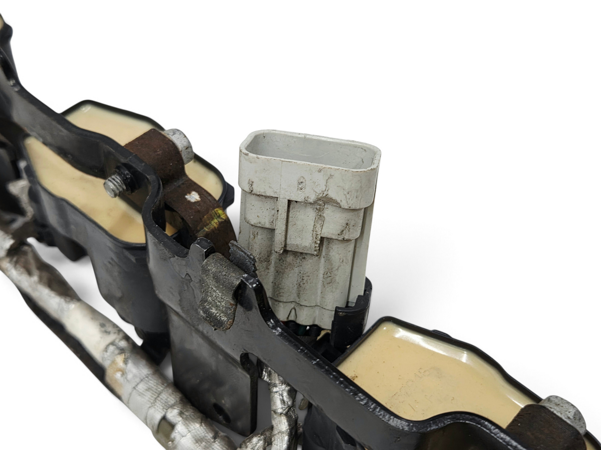 Send it Auto Parts OEM GM LS1 LS6 ignition coil bracket and harness assembly with a broken gray connector clip.