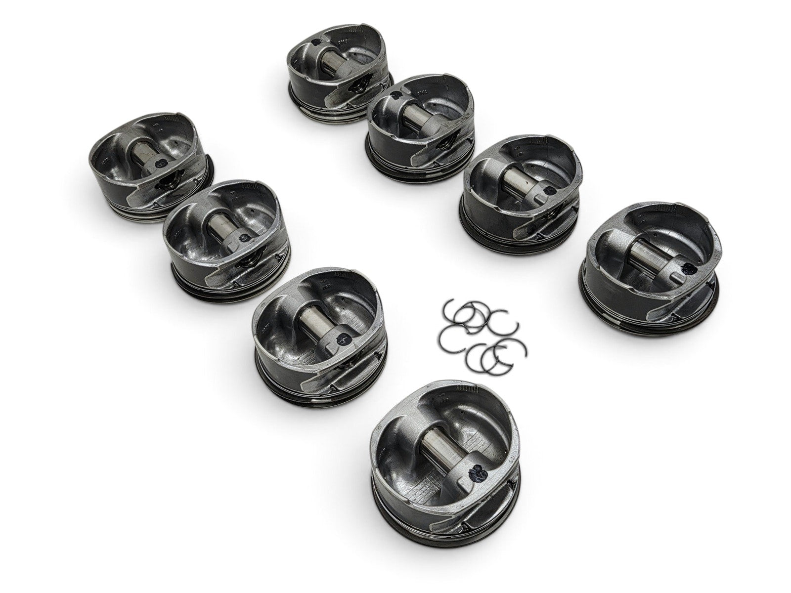 Send it Auto Parts set of 8 OEM GM 6.2L LS3 L92 L99 flat top pistons with pins and clips on a white background