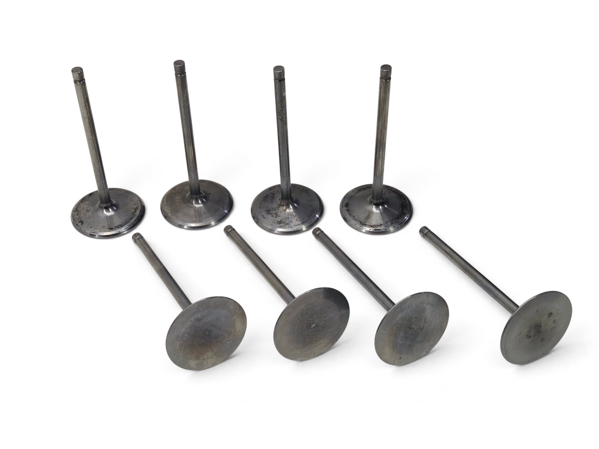 Send it Auto Parts set of eight 2.205 inch titanium intake valves for LS7 engines on a white surface.
