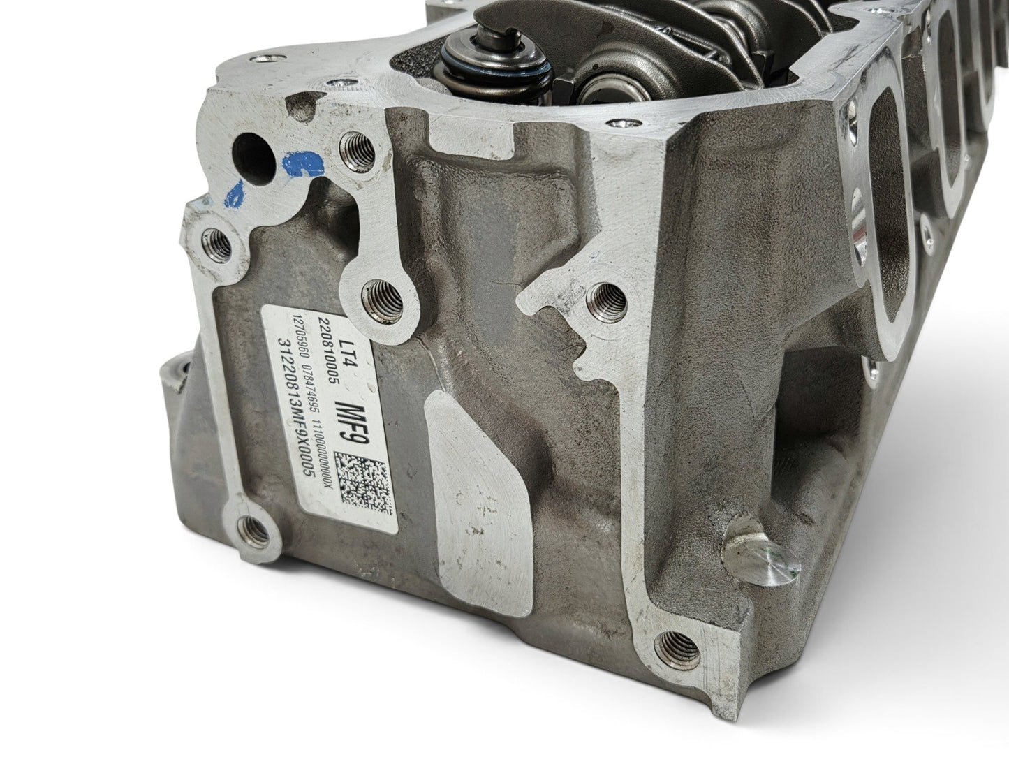 Send it Auto Parts OEM GM LT4 6.2L cylinder head with injector holes and lash caps for Corvette and Camaro engines.