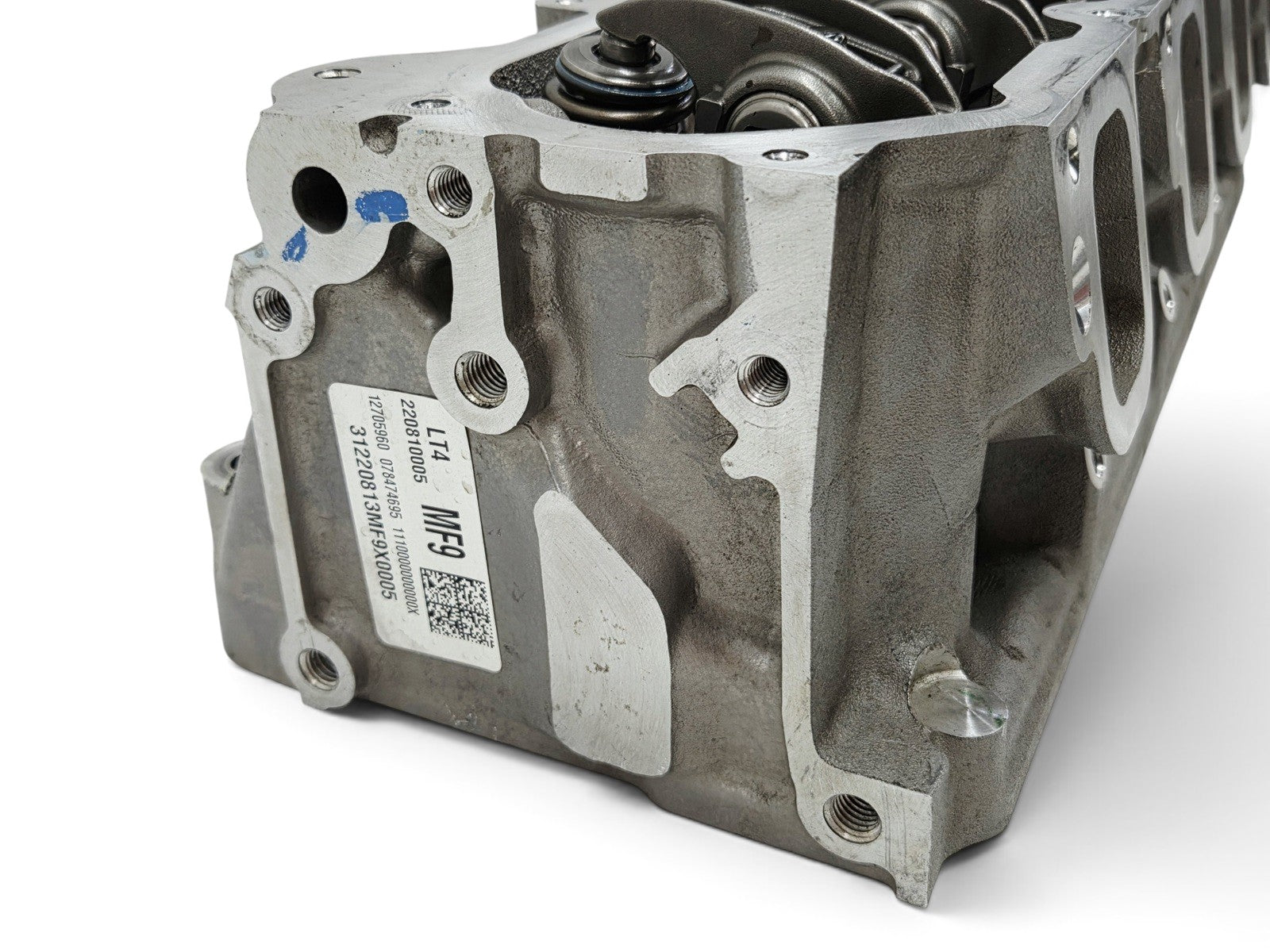 Send it Auto Parts OEM GM LT4 6.2L cylinder head with injector holes and lash caps for Corvette and Camaro engines.