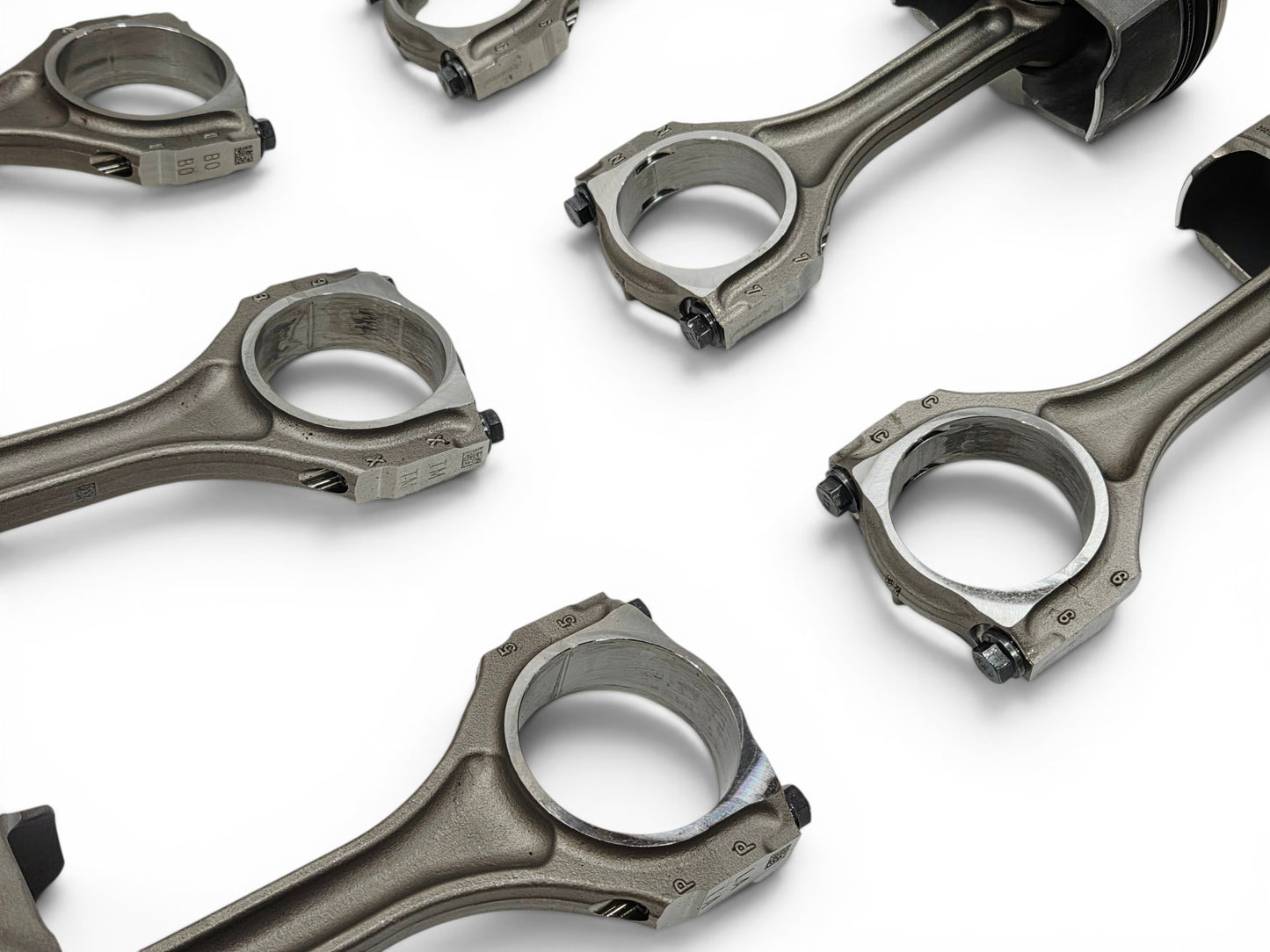 Send it Auto Parts OEM GM 6.2L LT4 supercharged engine pistons and upgraded Pankl connecting rods on white background.