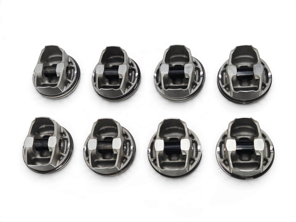 Send it Auto Parts set of 8 OEM GM LT4 6.2L supercharged engine pistons with pins and clips on a white surface.