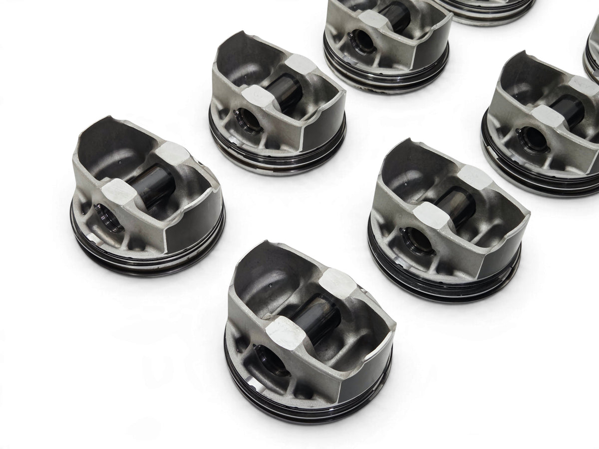 Send it Auto Parts set of 8 OEM GM 6.2L LT4 supercharged engine pistons with pins and clips on a white surface
