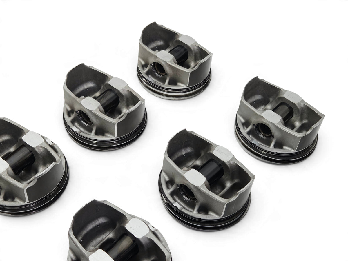 Send it Auto Parts set of 8 OEM GM LT4 6.2L supercharged engine pistons with pins and clips on a white background