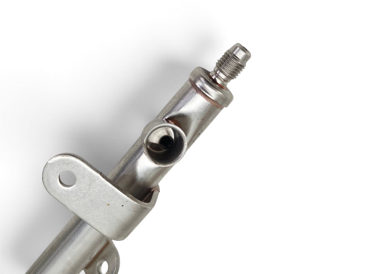 Send it Auto Parts OEM GM fuel injector rail for LS2 and LS3 engines, showing metal construction and mounting bracket.