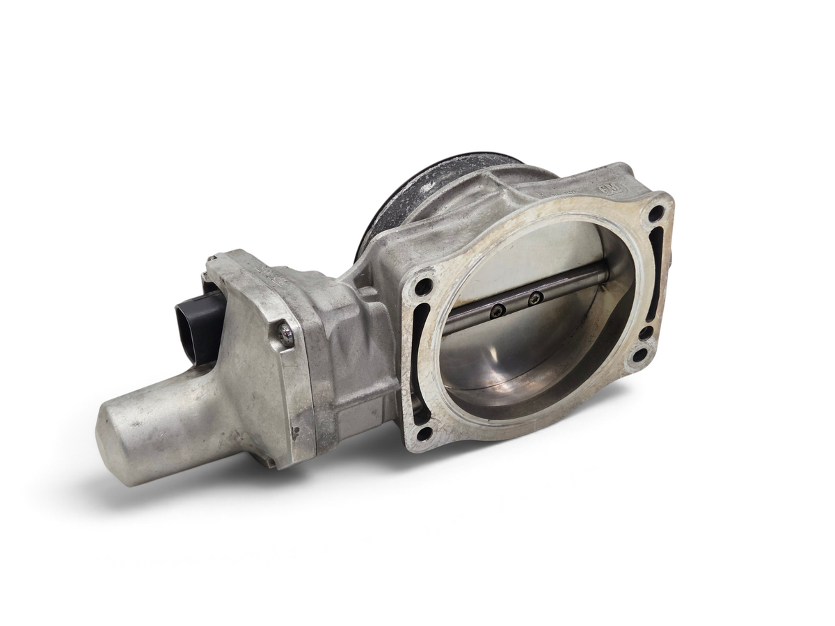 Send it Auto Parts OEM silver throttle body for GM LS engines, showing internal blade and mounting bolt holes.